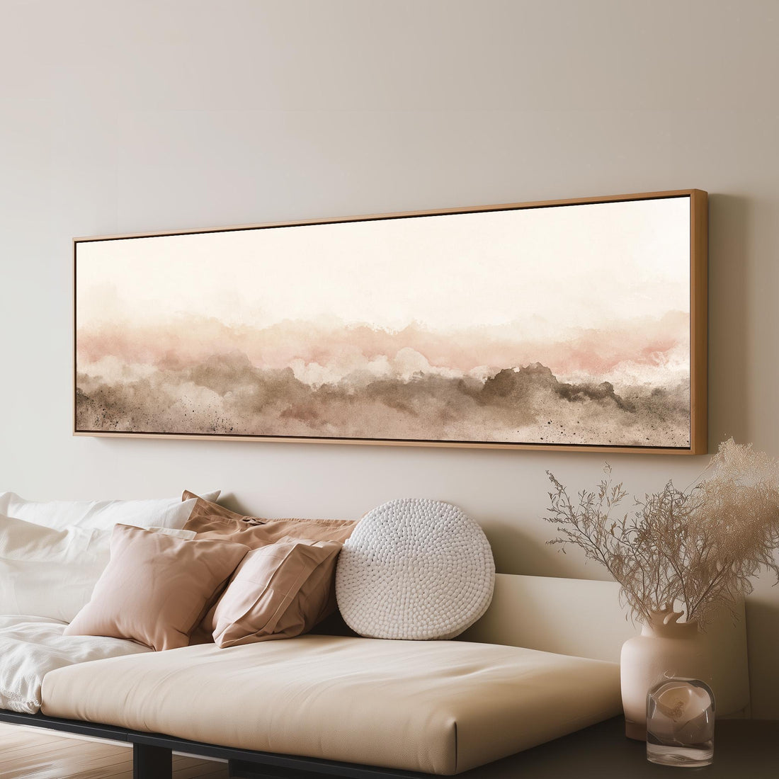 Blush watercolor mountain silhouette long horizontal canvas print above a sofa in a living room
