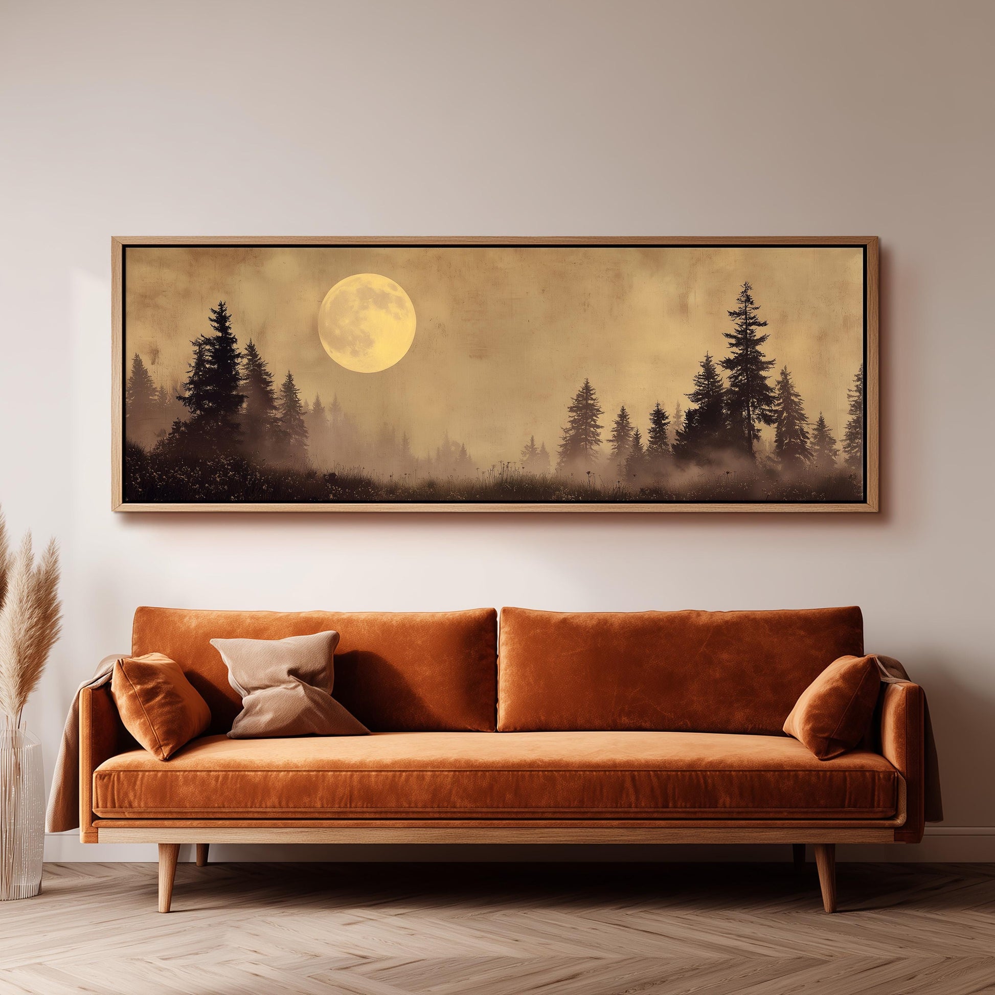 a large, framed painting of a forest scene with a full moon in the background.