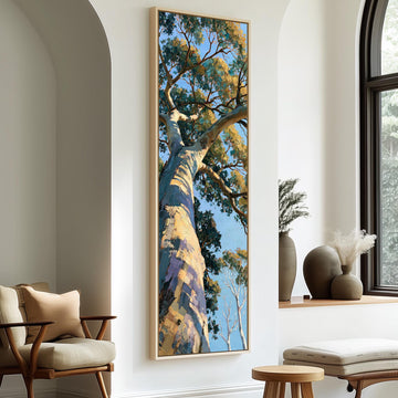 Gum tree trunk rising into a sunlit canopy long vertical canvas print in a sunlit living space