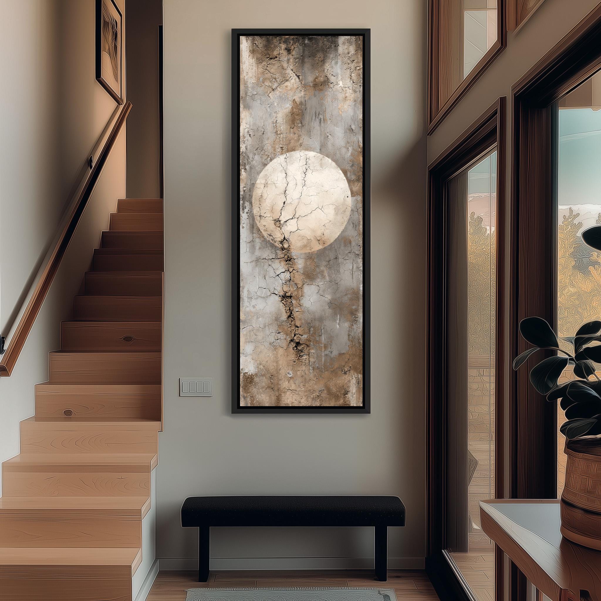 a hallway with a large painting hanging on the wall, a wooden staircase, a black bench, and a plant in a pot.