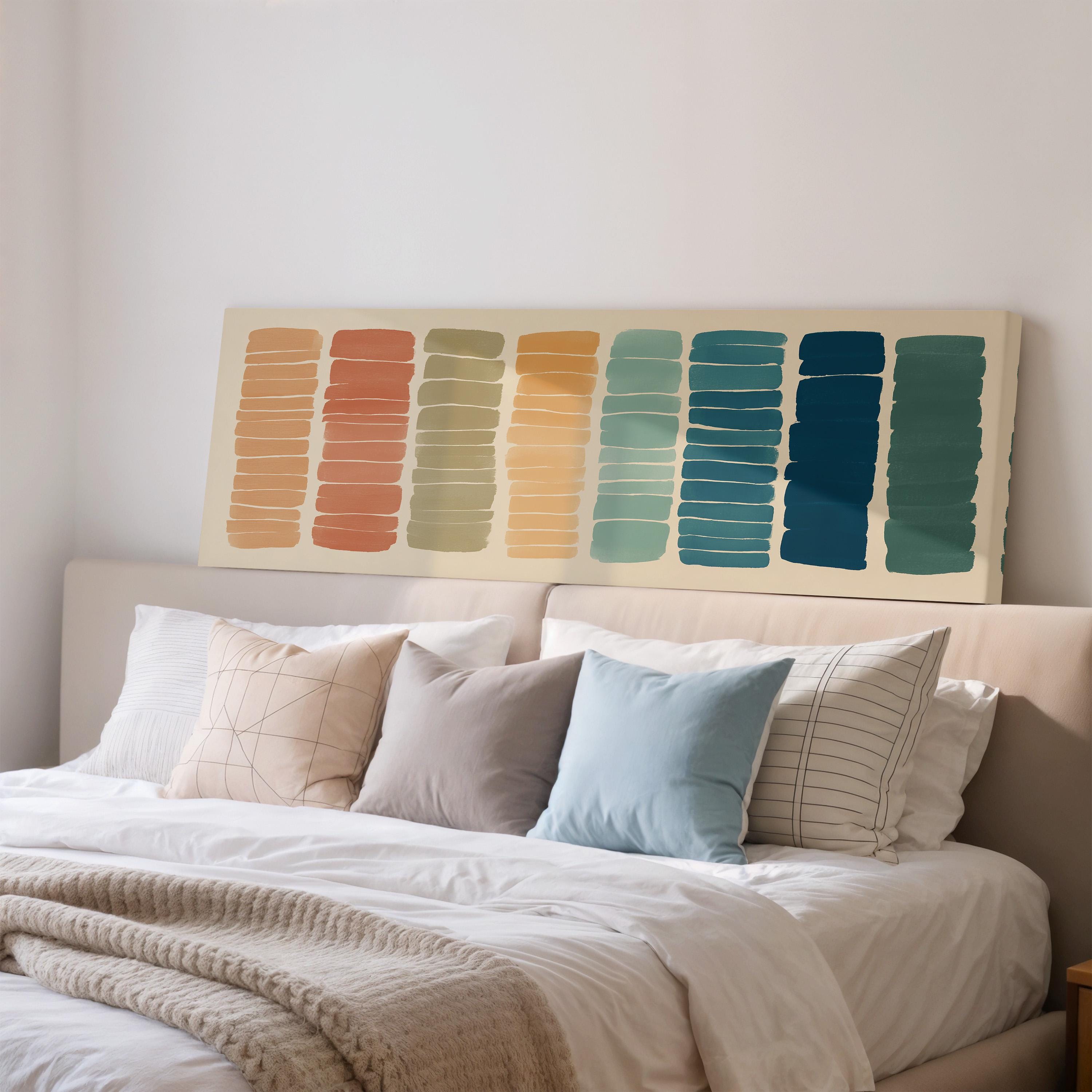 a cozy bedroom with a bed adorned with various pillows and a large abstract painting hanging above it.