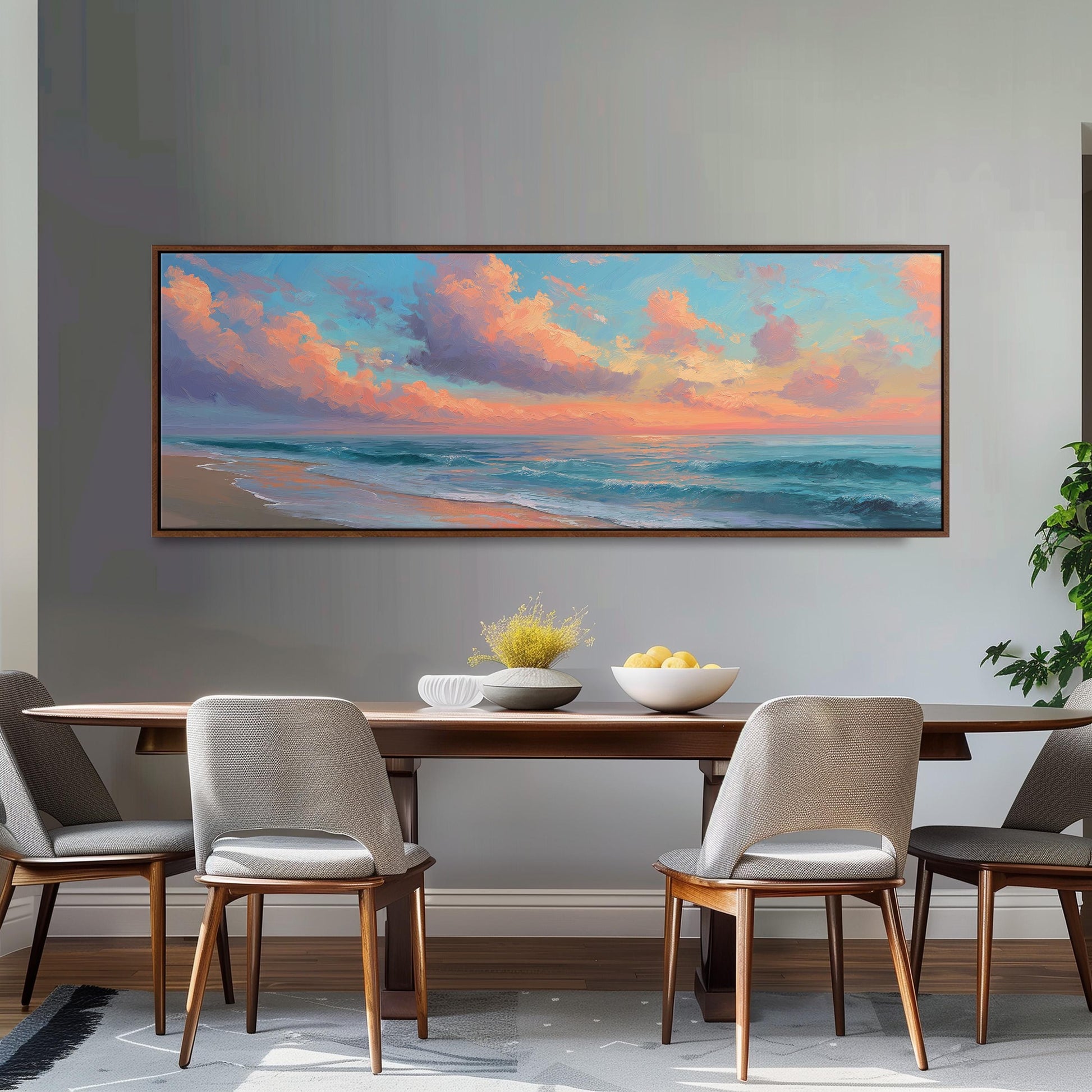a large painting of a serene beach scene hanging on a wall above a wooden dining table with four chairs. The painting depicts a tranquil beach with a colorful sky and ocean, creating a peaceful and relaxing atmosphere.