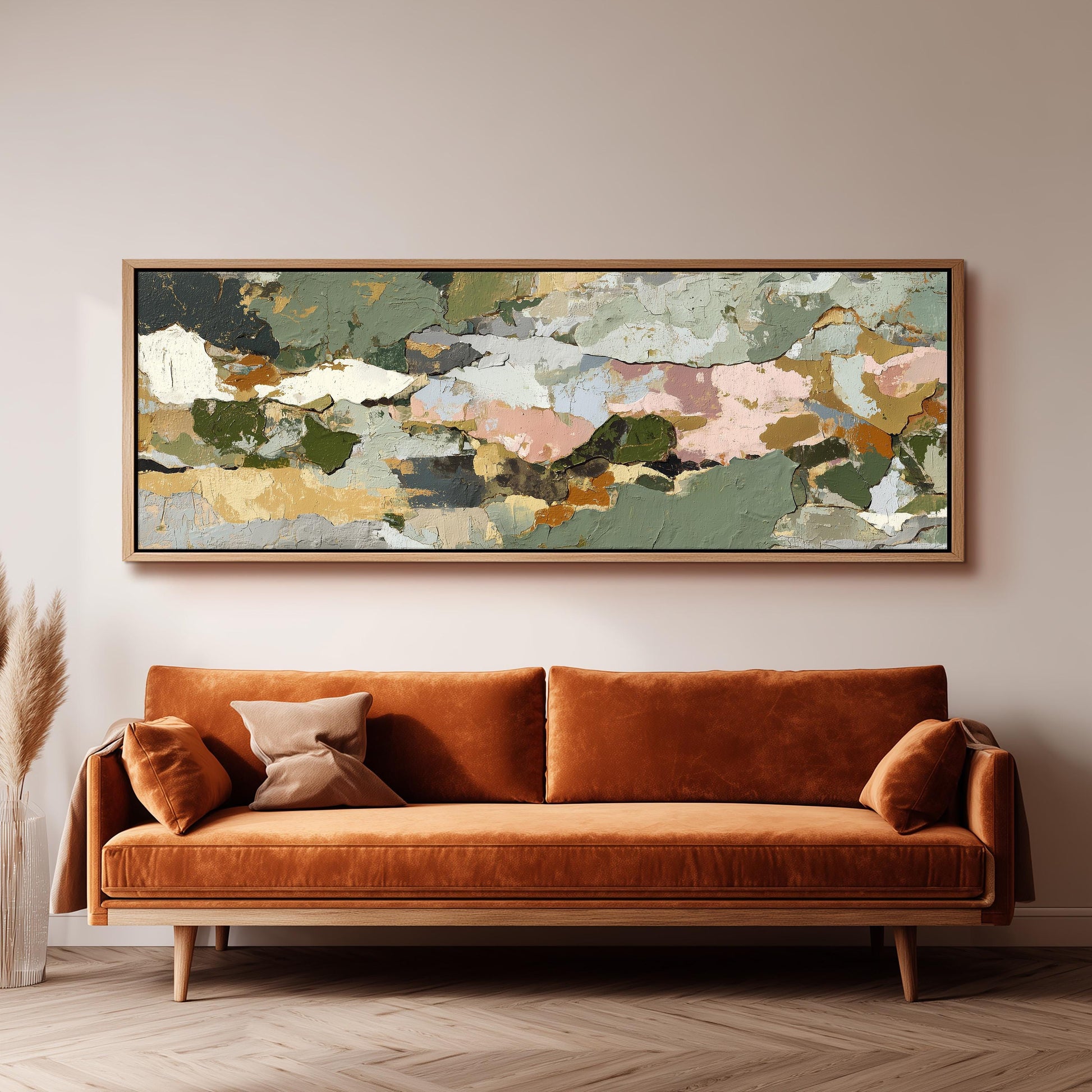 a large abstract painting hanging on a wall above a brown sofa with orange cushions.