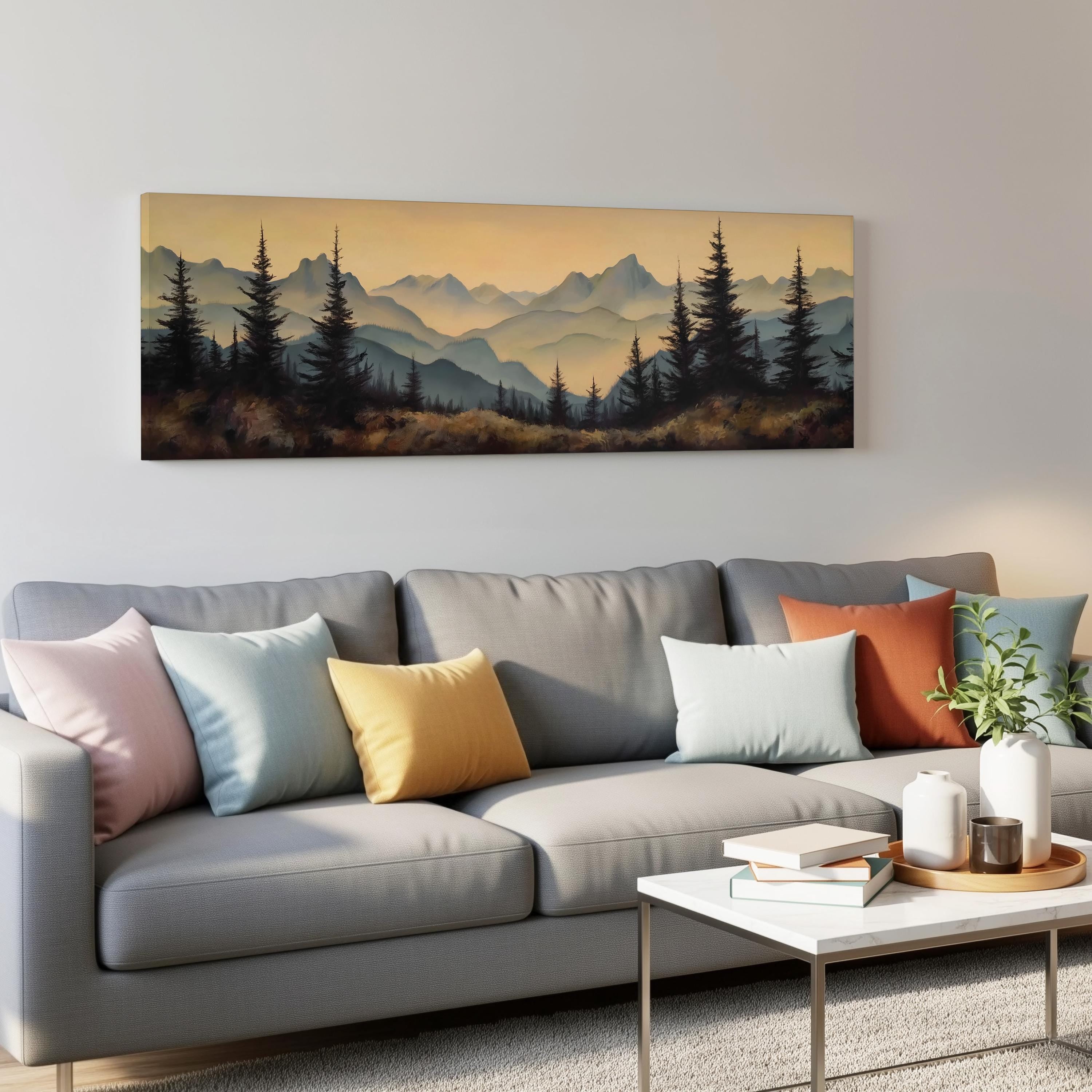 a living room with a gray sofa adorned with colorful throw pillows, a coffee table with books and a plant, and a large landscape painting hanging on the wall above the sofa.