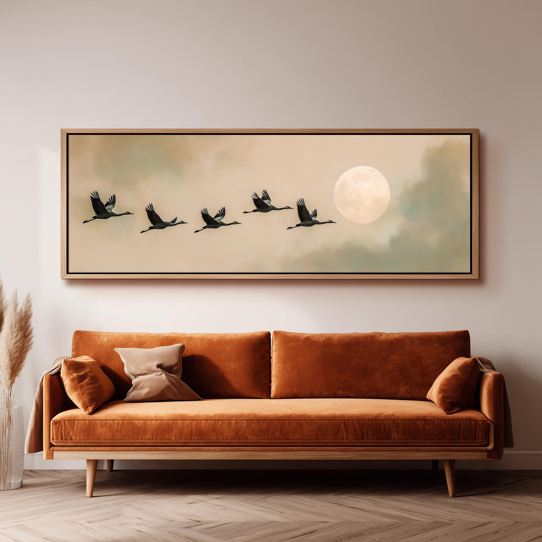 a large framed painting of a flock of birds flying in formation, with a full moon in the background.