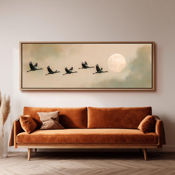 a large framed painting of a flock of birds flying in formation, with a full moon in the background.