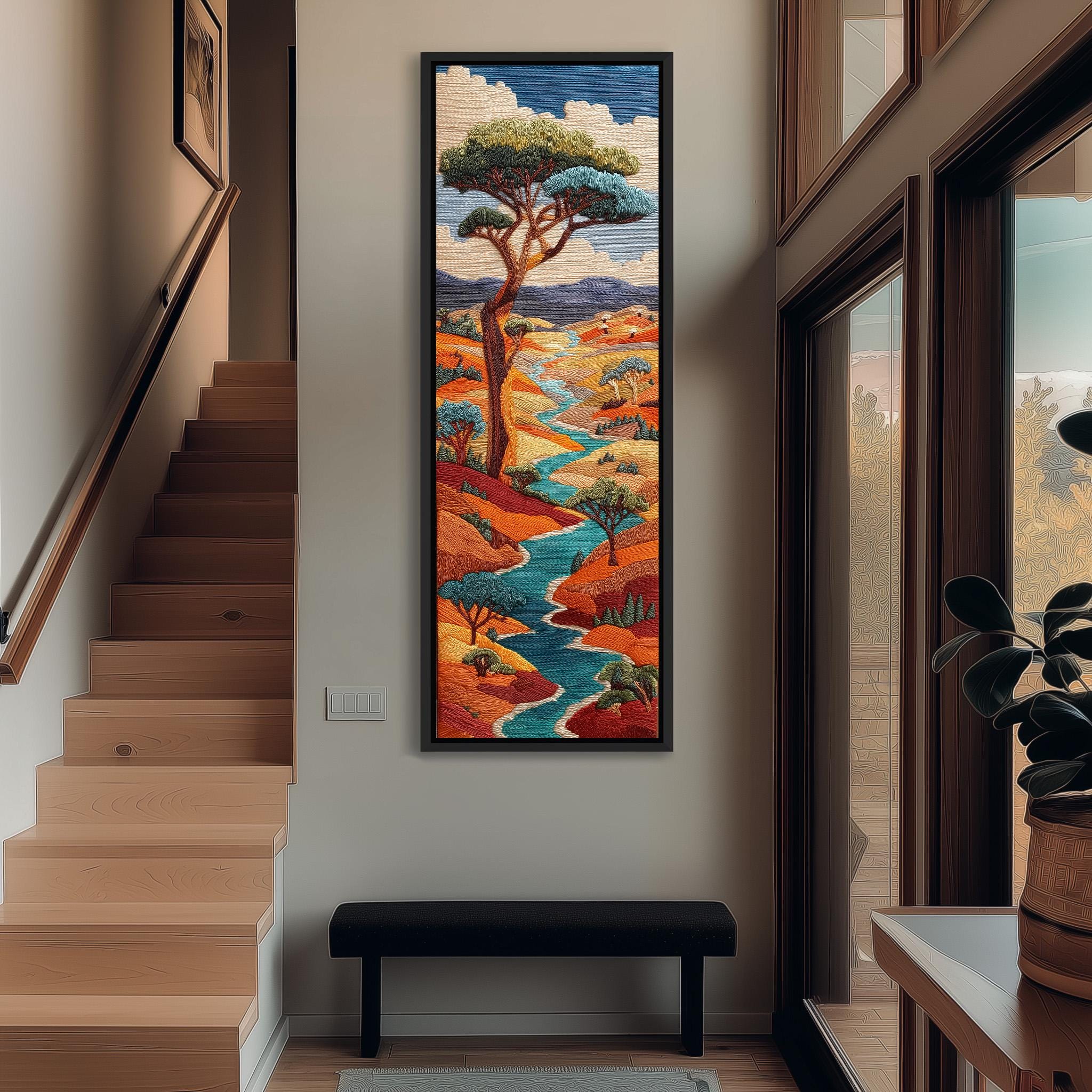 a large, colorful painting of a landscape hanging on the wall of a room with wooden stairs and a bench.
