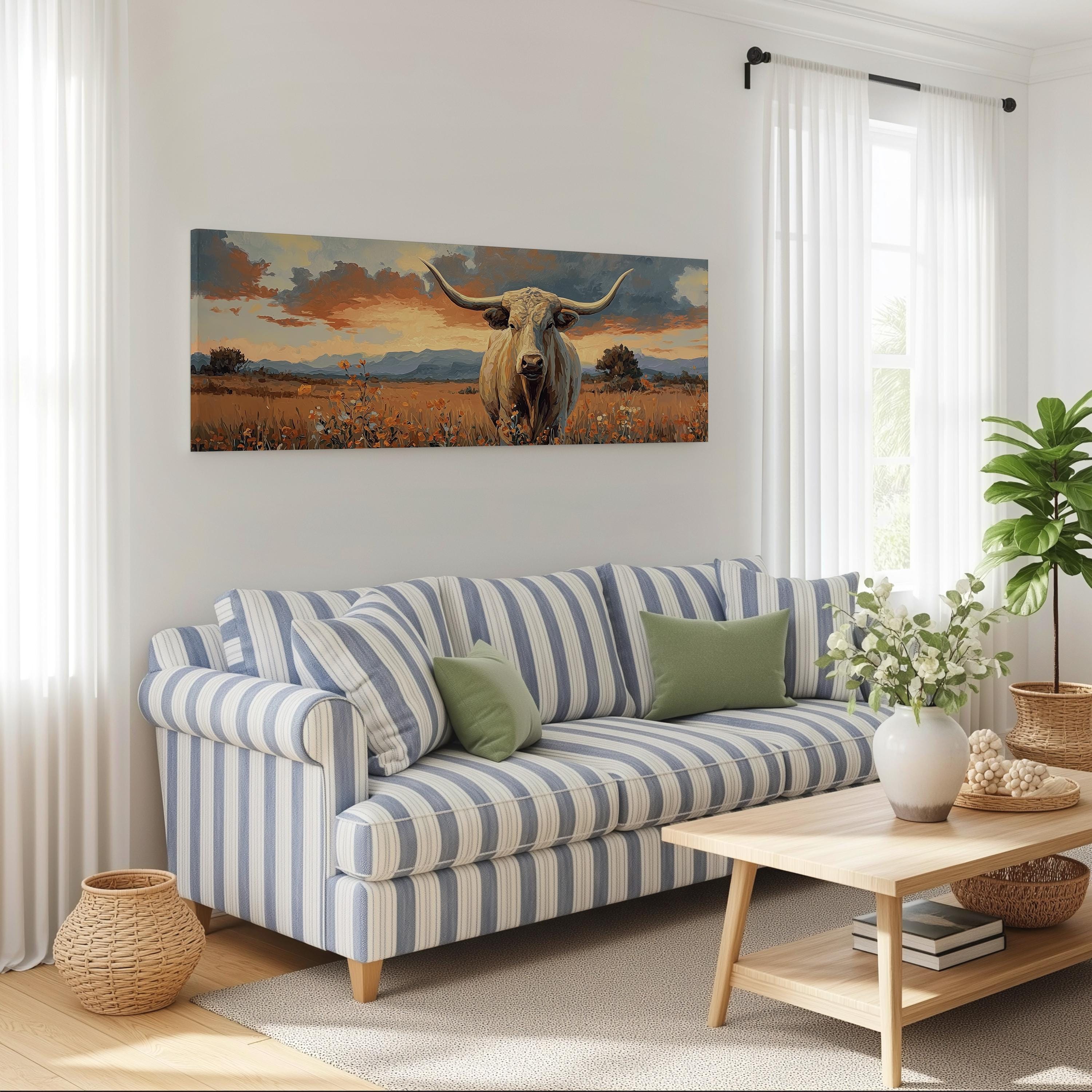 a living room with a blue and white striped sofa, a wooden coffee table, and a large painting of a bull with horns hanging on the wall above the sofa.