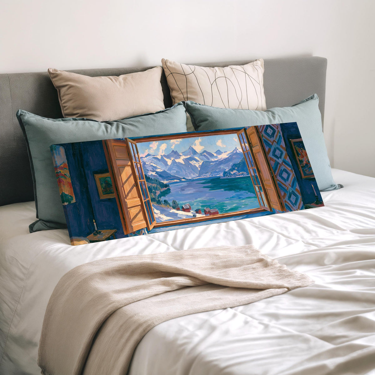 Snowy alpine lake seen through a window wide panoramic canvas print laid on a bed to show its size