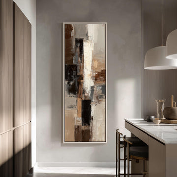 a modern kitchen with a large abstract painting hanging on the wall above a counter. The painting has a mix of brown, white, and black colors, creating a visually striking contrast. The kitchen is well-lit, with natural light coming in from a window on the left side of the image. The counter is equipped with a sink and a few decorative items, such as a vase and a bowl.