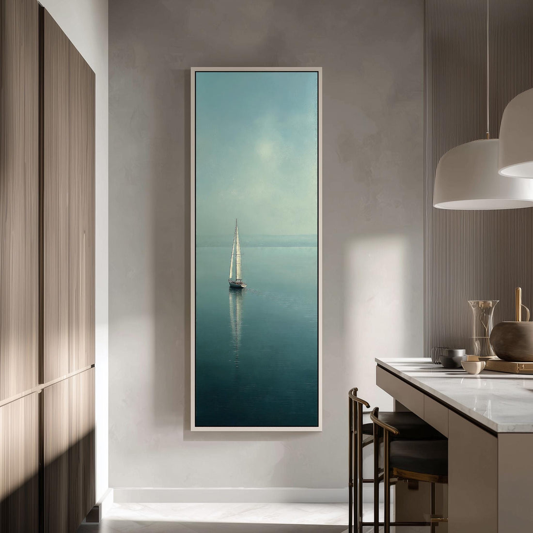 a large framed picture of a sailboat on the water, hanging on a wall in a modern kitchen.