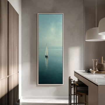 a large framed picture of a sailboat on the water, hanging on a wall in a modern kitchen.