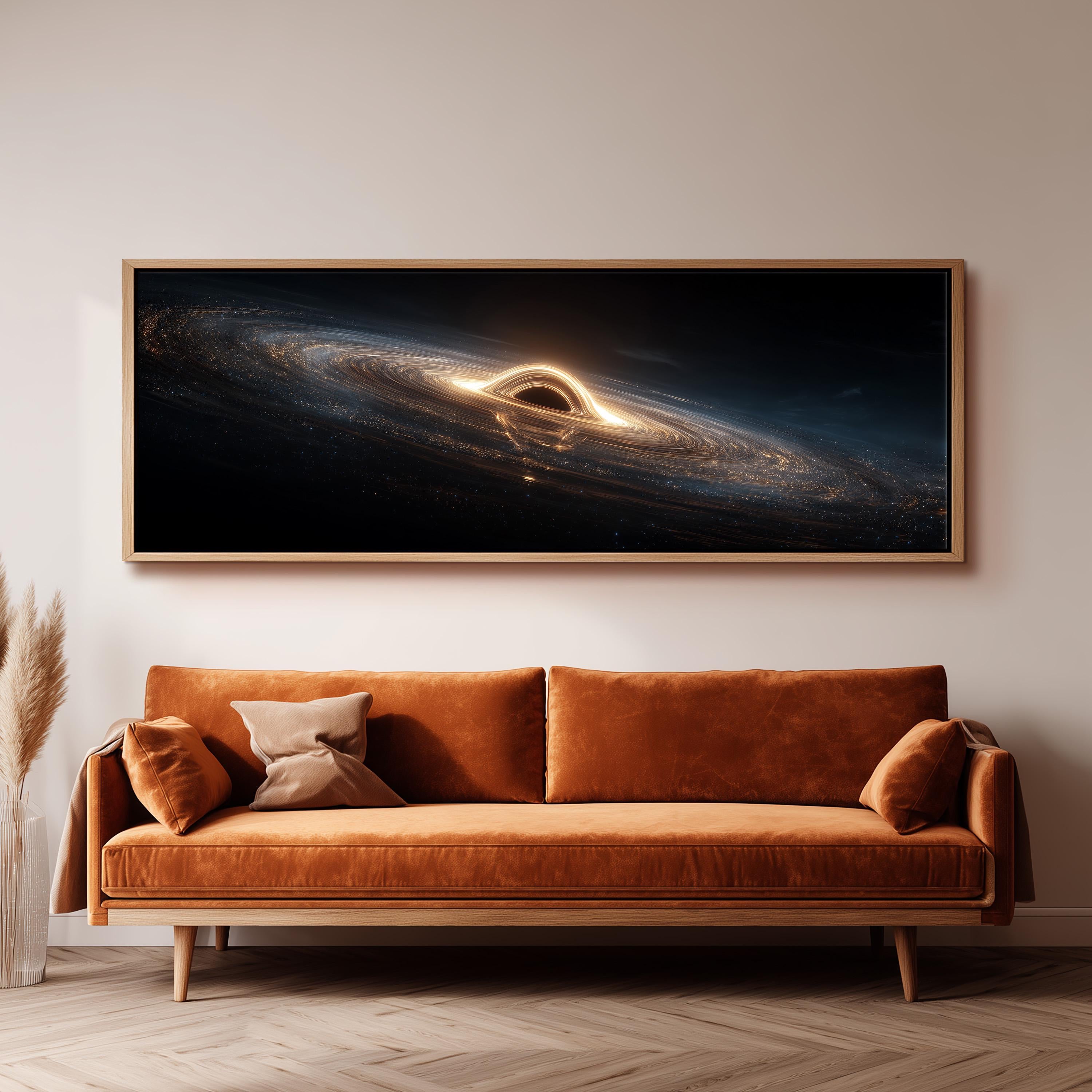 a large, framed artwork depicting a black hole with a bright light at its center, hanging on a wall above a brown sofa.