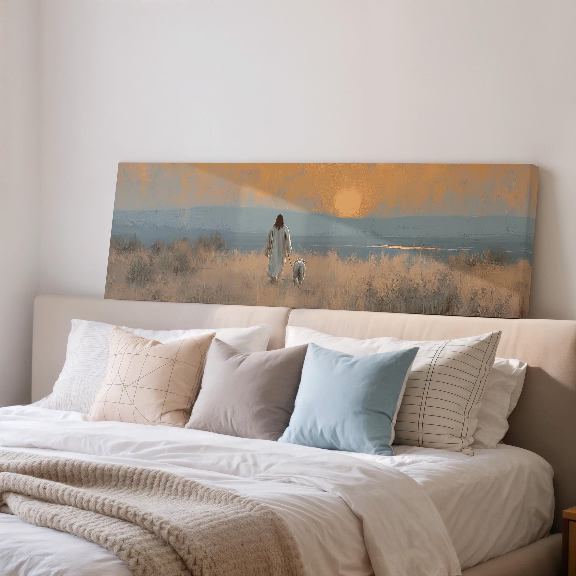 a large canvas print depicting a person walking a dog in a field with a sunset in the background.