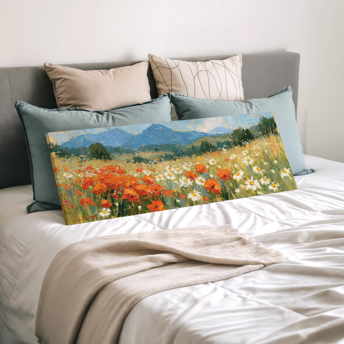 Alpine poppy and daisy meadow wide panoramic canvas print laid on a bed to show its size