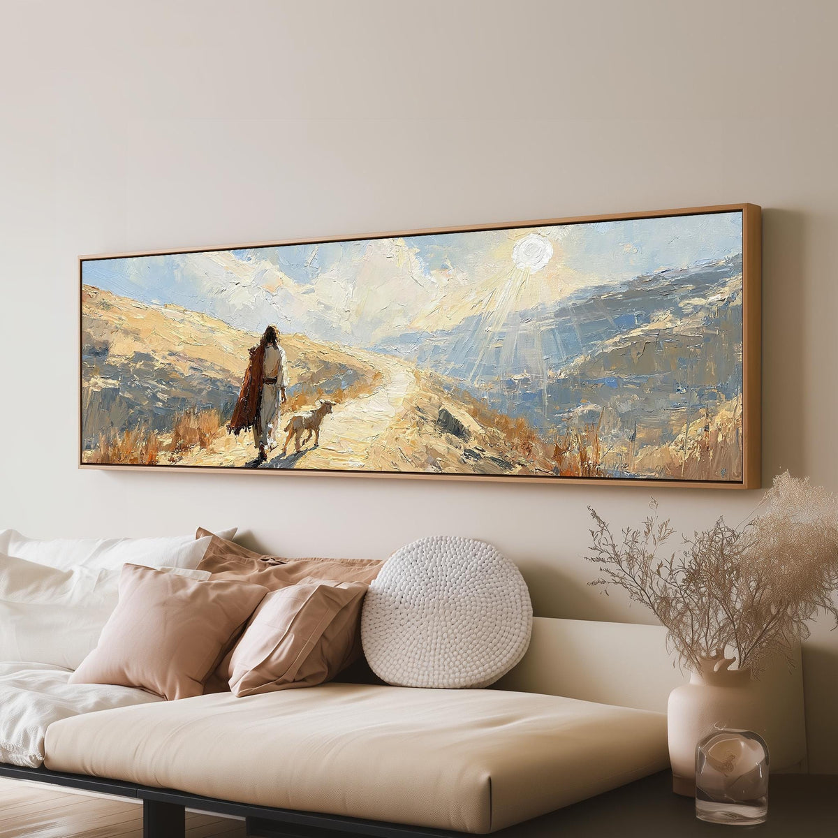 Jesus walking a sunlit hillside path with a sheep panoramic canvas print above a sofa in a living room