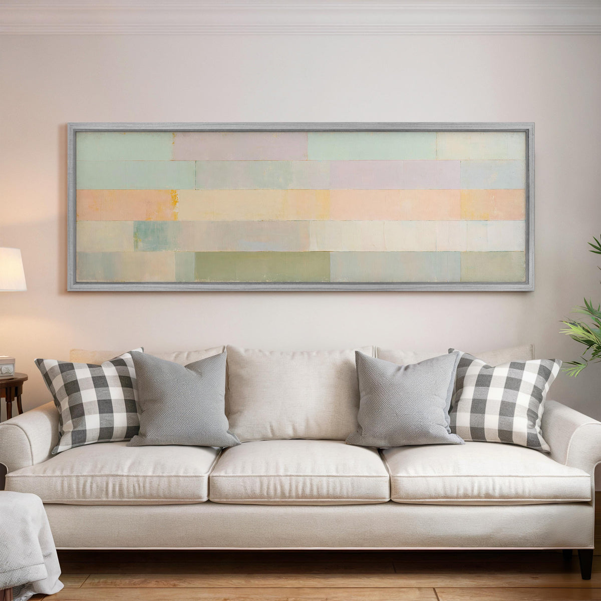 Soft lilac, mint and butter color bands panoramic canvas print above a white sofa in a bright living room
