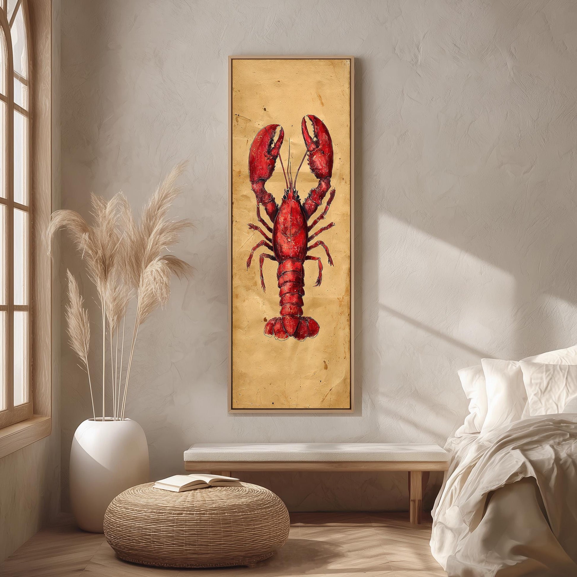 a large framed picture of a red lobster on a wall, with a white bed and a wicker ottoman in the foreground.