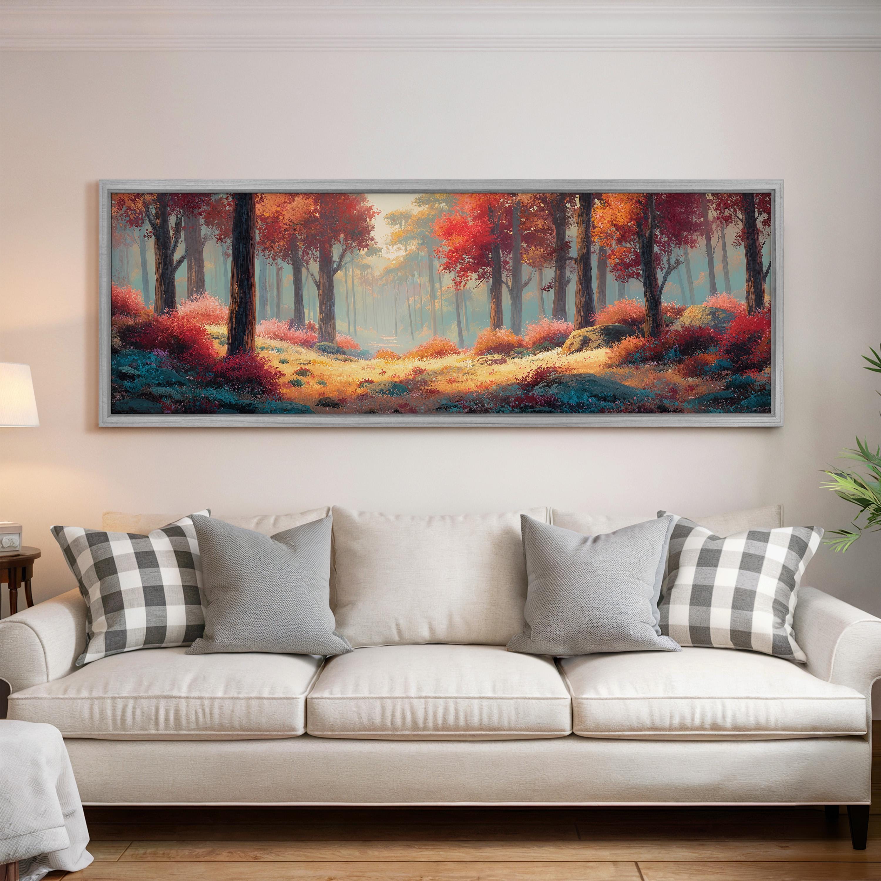 a large, colorful painting of a forest scene hanging on a wall above a white couch with gray and white patterned pillows.