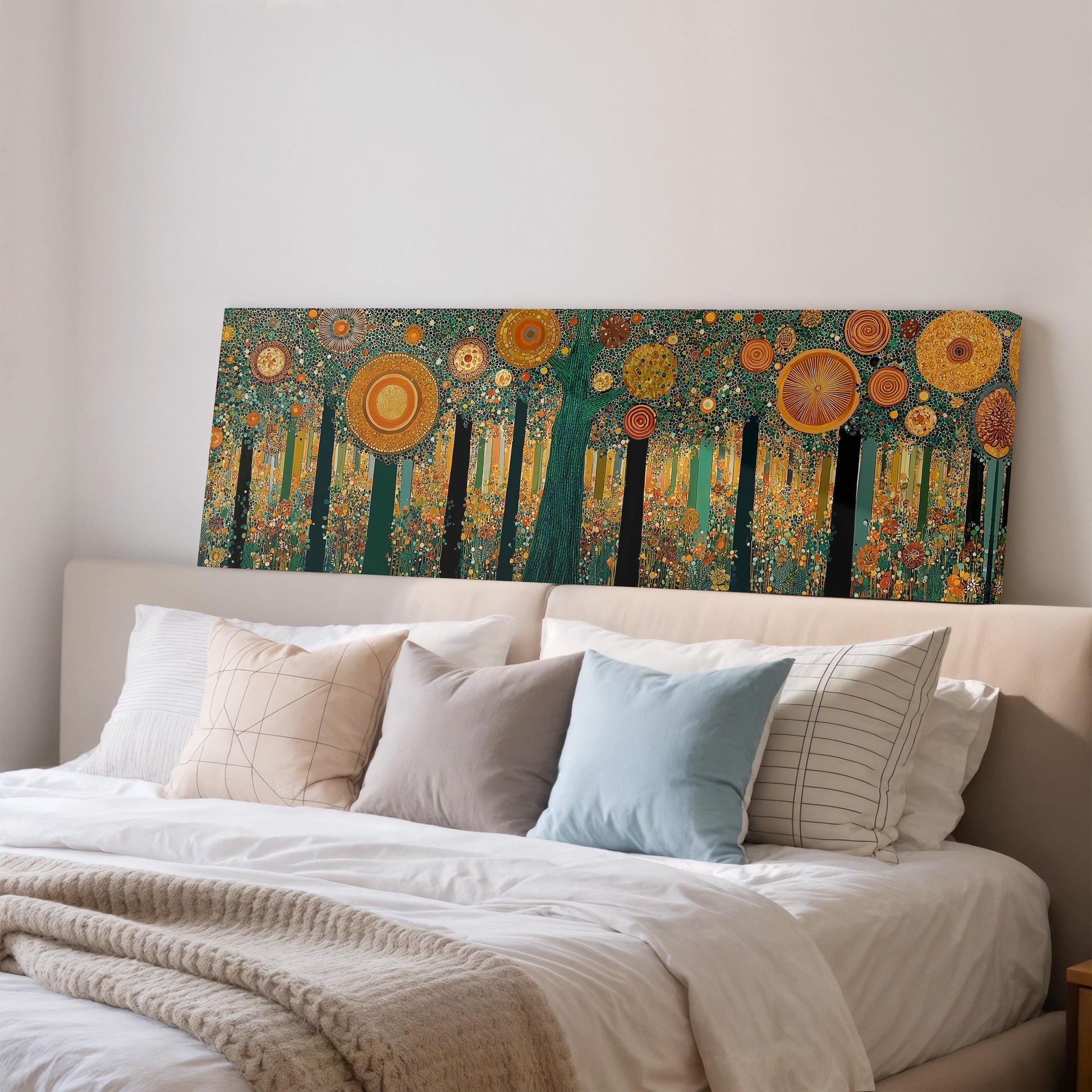 a large, colorful painting of a forest scene hanging on a wall above a bed with white pillows and a gray blanket.