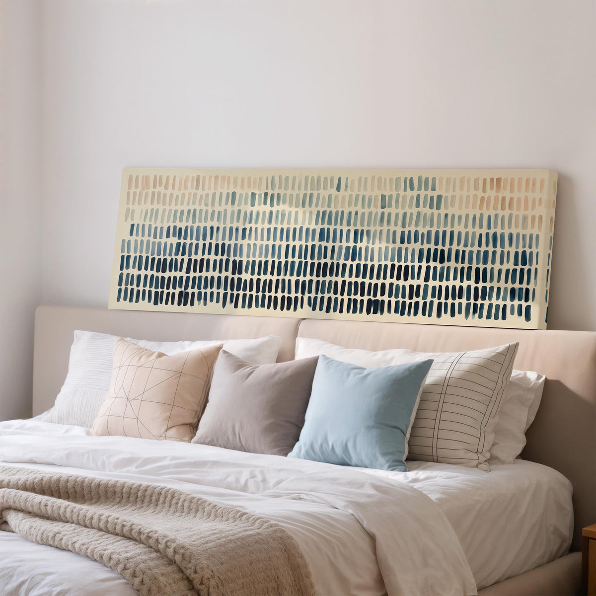 Brushmarks fading from peach to navy wide panoramic canvas print above a bed in a bedroom