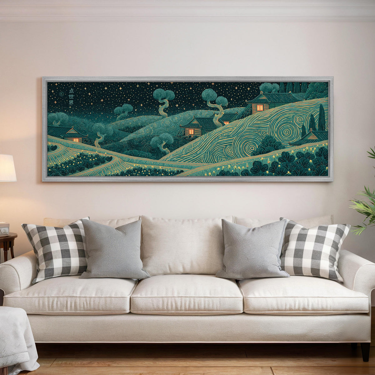Village on swirling hills at night panoramic canvas print above a white sofa in a bright living room