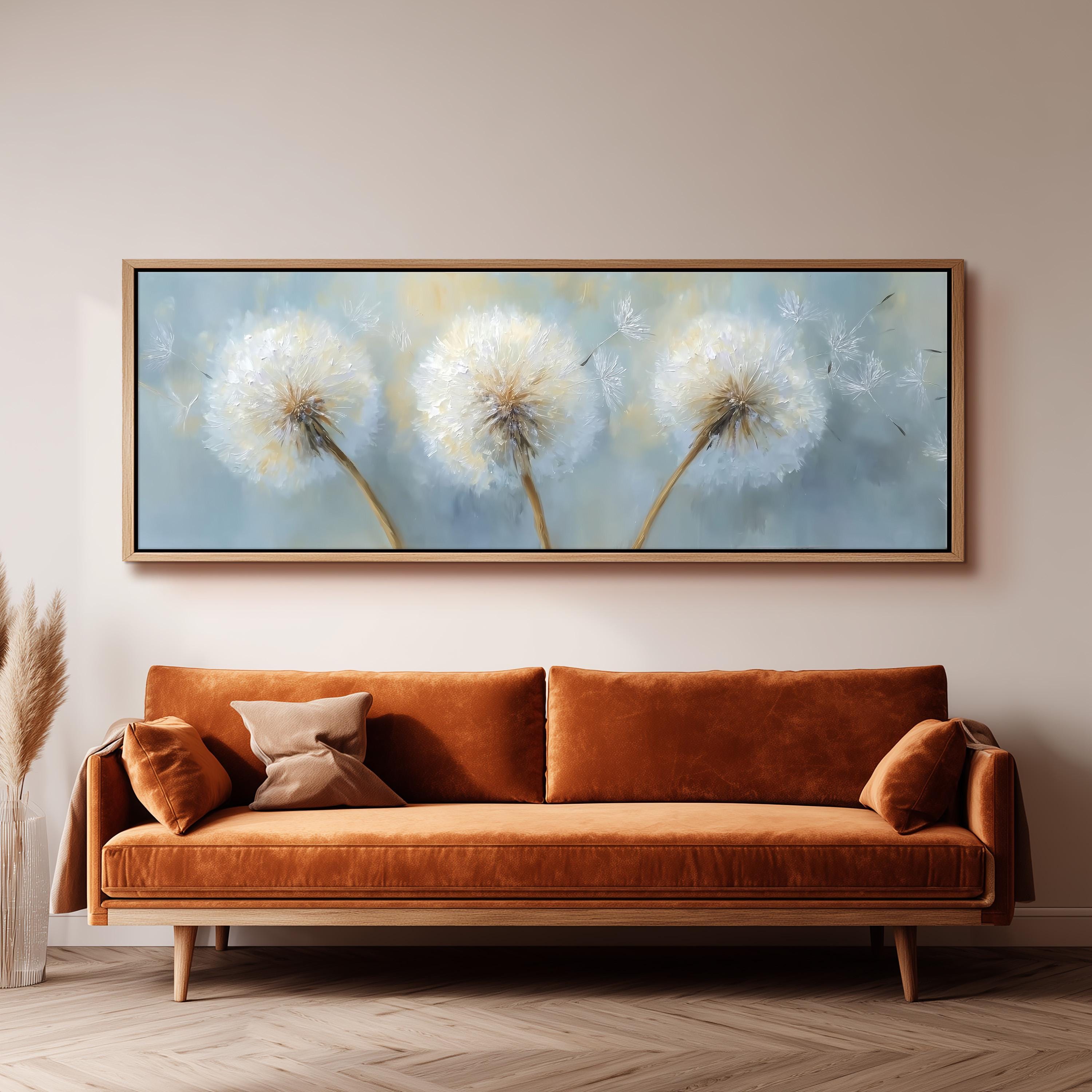 a large painting of three dandelions hanging on a wall above a brown sofa in a living room.