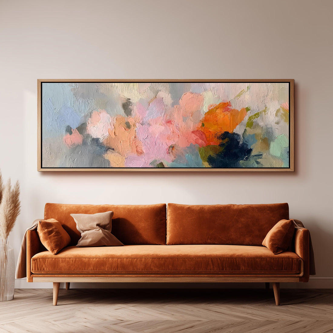 a large, abstract painting hanging on a wall above a brown sofa with two pillows.