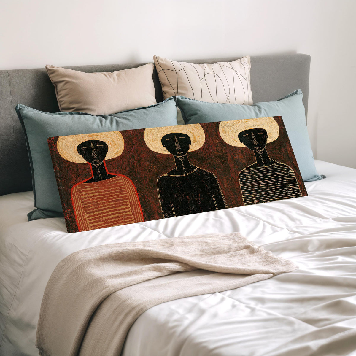 Three figures in striped shirts wide panoramic canvas print laid on a bed to show its size