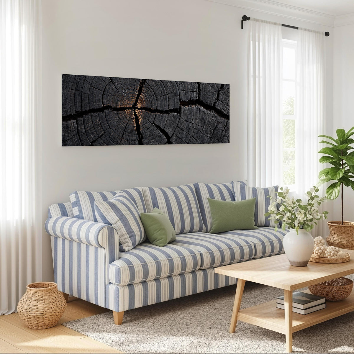 Charcoal tree ring cross section long horizontal canvas print above a striped sofa in a coastal living room