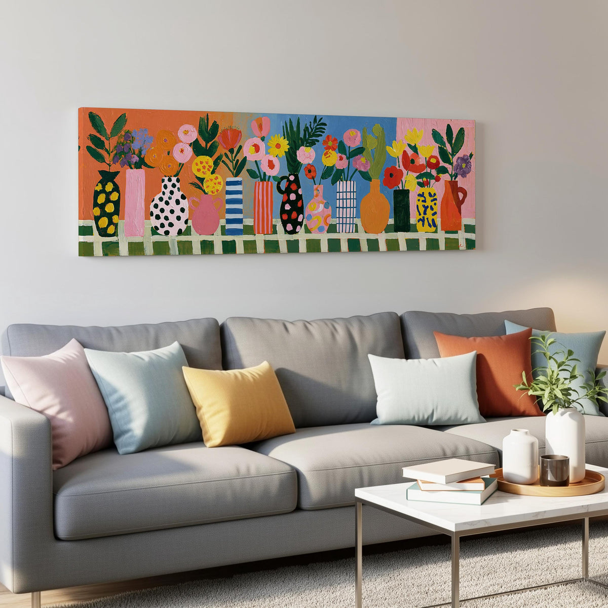 Patterned vases with bright bouquets panoramic canvas print above a grey sofa in a living room