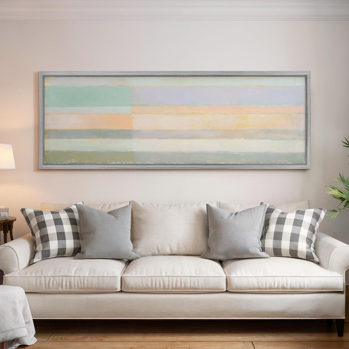 Mint, lavender and peach pastel bands panoramic canvas print above a white sofa in a bright living room