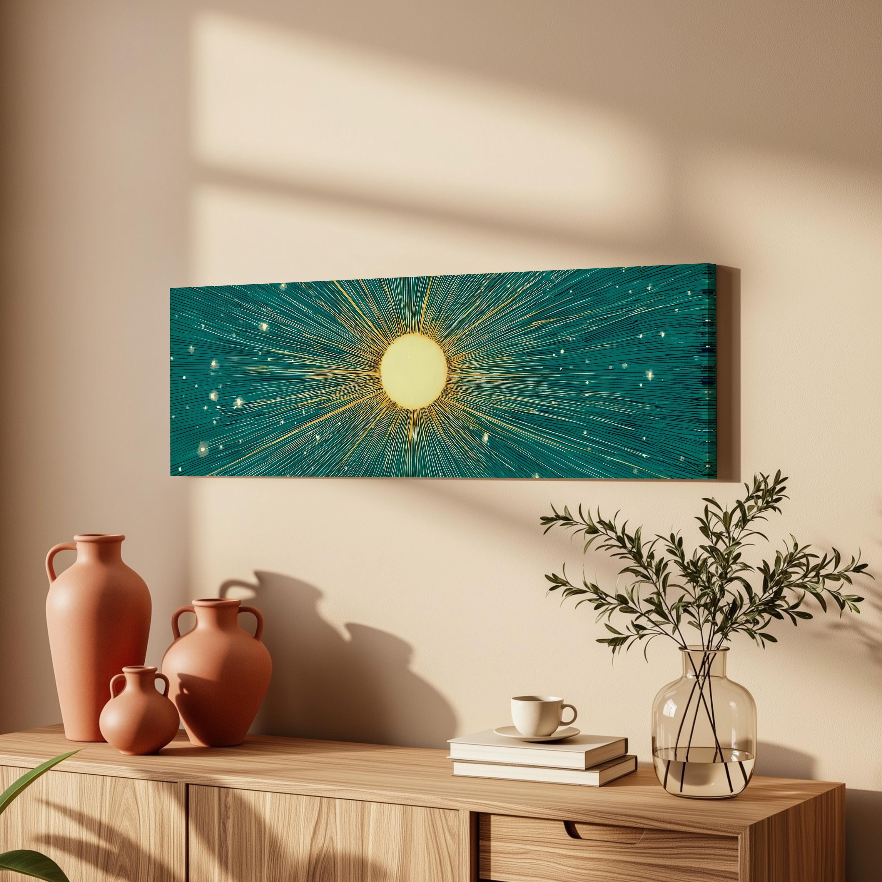 a wooden cabinet with a vase of greenery, a coffee cup, and a stack of books on top. Above the cabinet, there is a framed artwork depicting a sun with rays radiating from it, creating a warm and inviting atmosphere in the room.