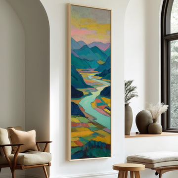 a large, colorful painting of a landscape hanging on a wall in a room with a window and a wooden chair.