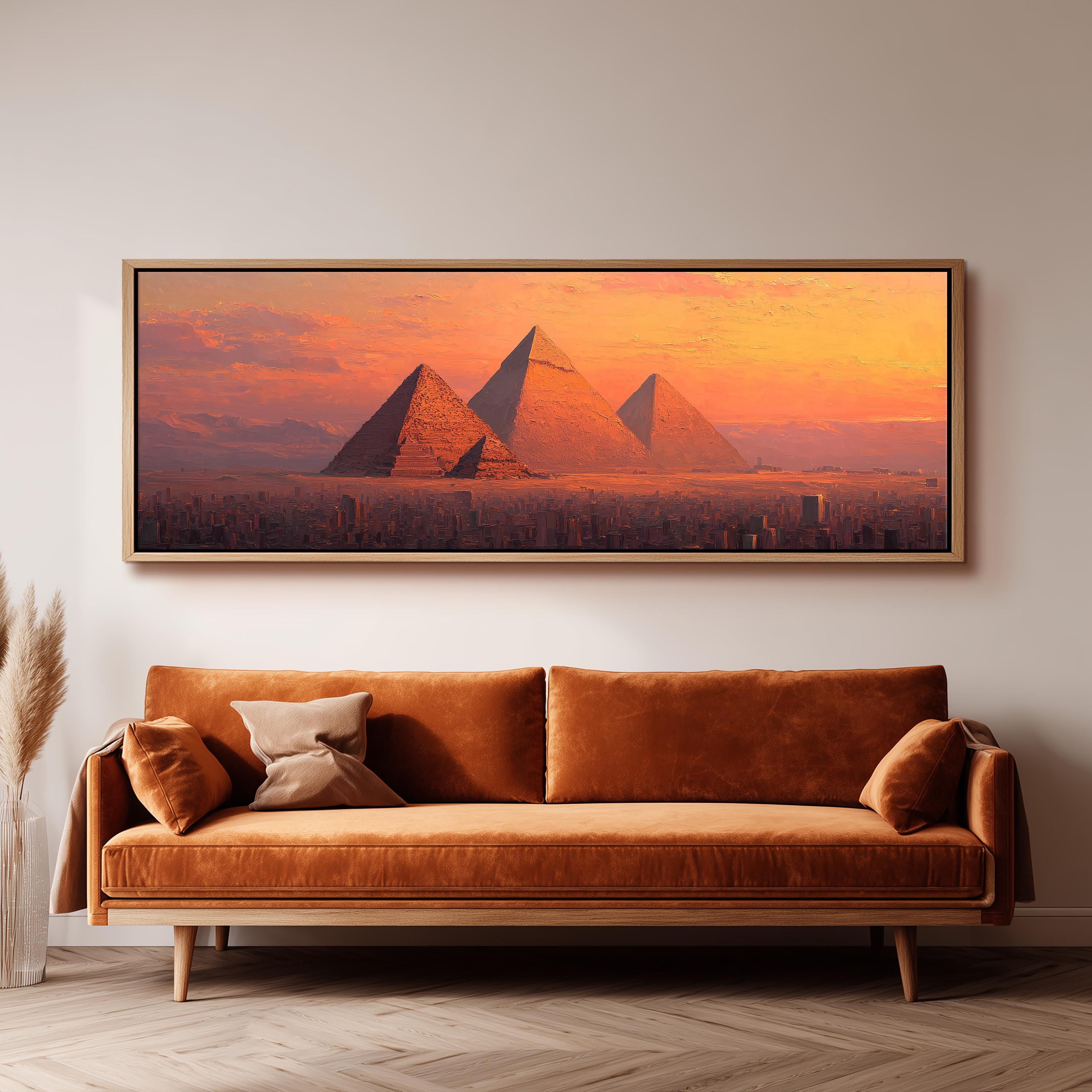 a large, framed painting of the pyramids of Giza in Egypt, with a warm, orange and yellow sunset in the background.