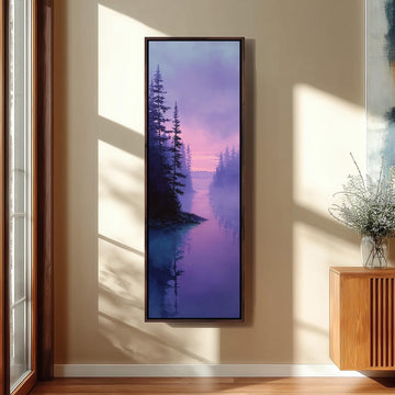a large framed painting of a serene landscape with a forest and a body of water, hanging on a wall in a room with a wooden floor and a window.
