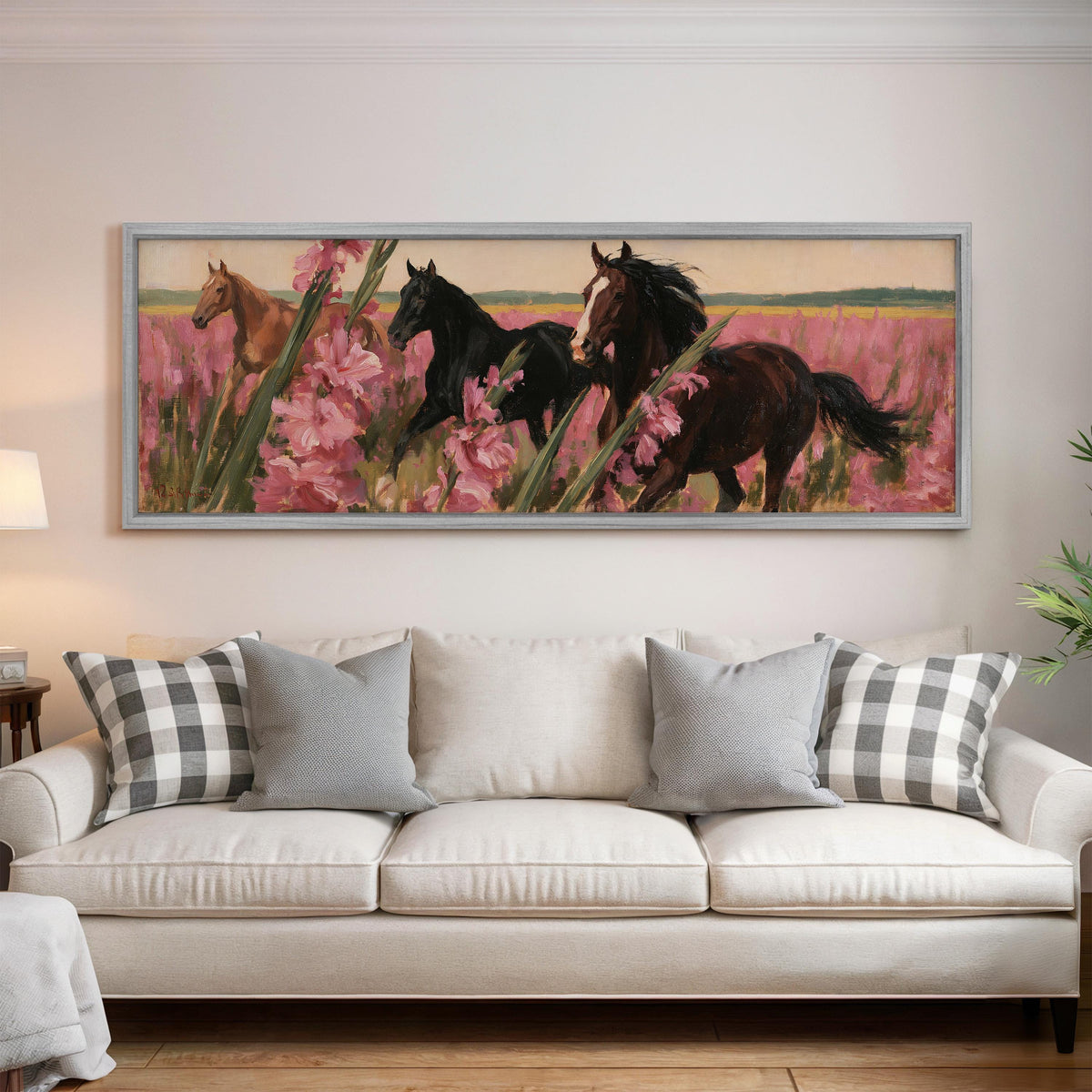 Horses running through pink gladiolus panoramic canvas print above a white sofa in a bright living room