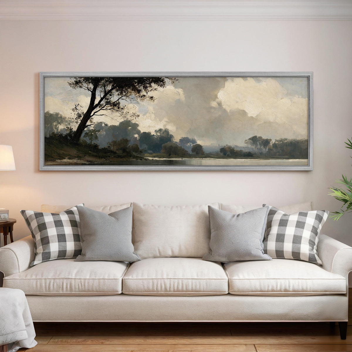 Misty river landscape in grey blue tones panoramic canvas print above a white sofa in a bright living room