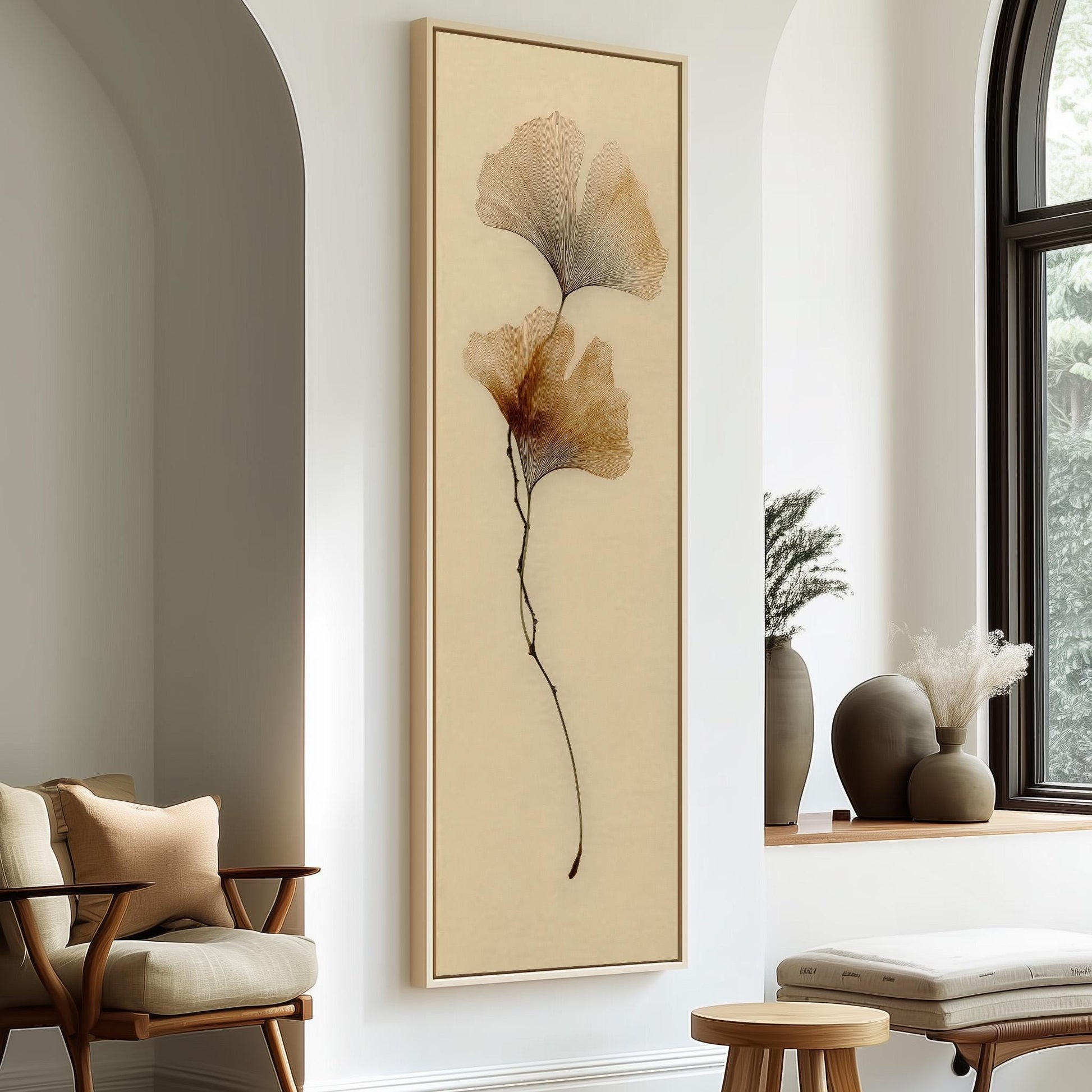 a minimalist living room with a large framed artwork of a plant on the wall, a wooden chair, a small table, and a window with a plant on the sill.