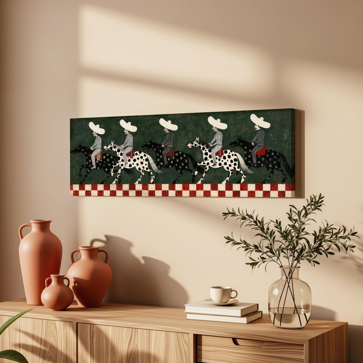 Riders in sombreros on spotted horses long horizontal canvas print above a wooden sideboard