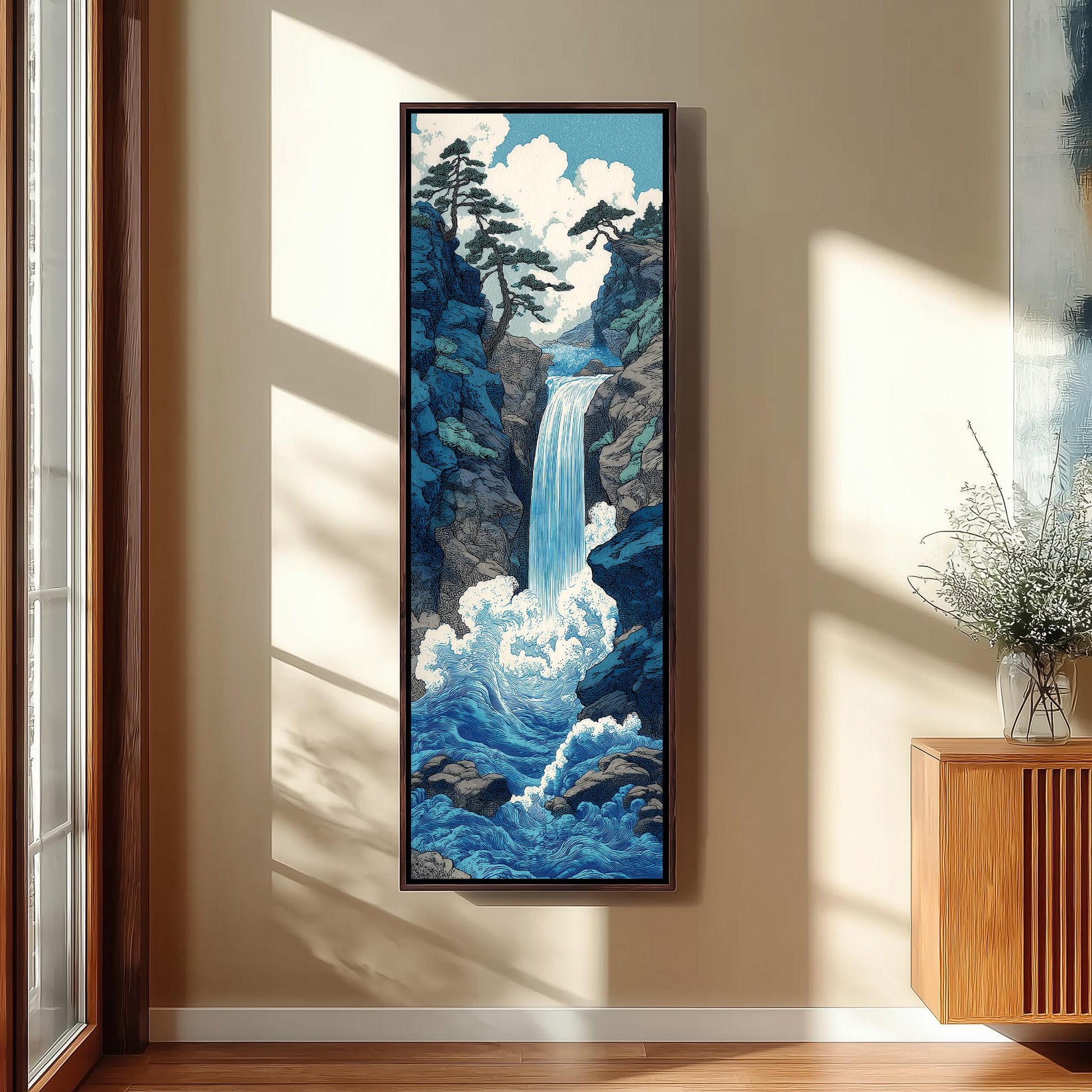 a large framed painting of a waterfall in a serene landscape, hanging on a wall in a room with a wooden cabinet and a vase of flowers.