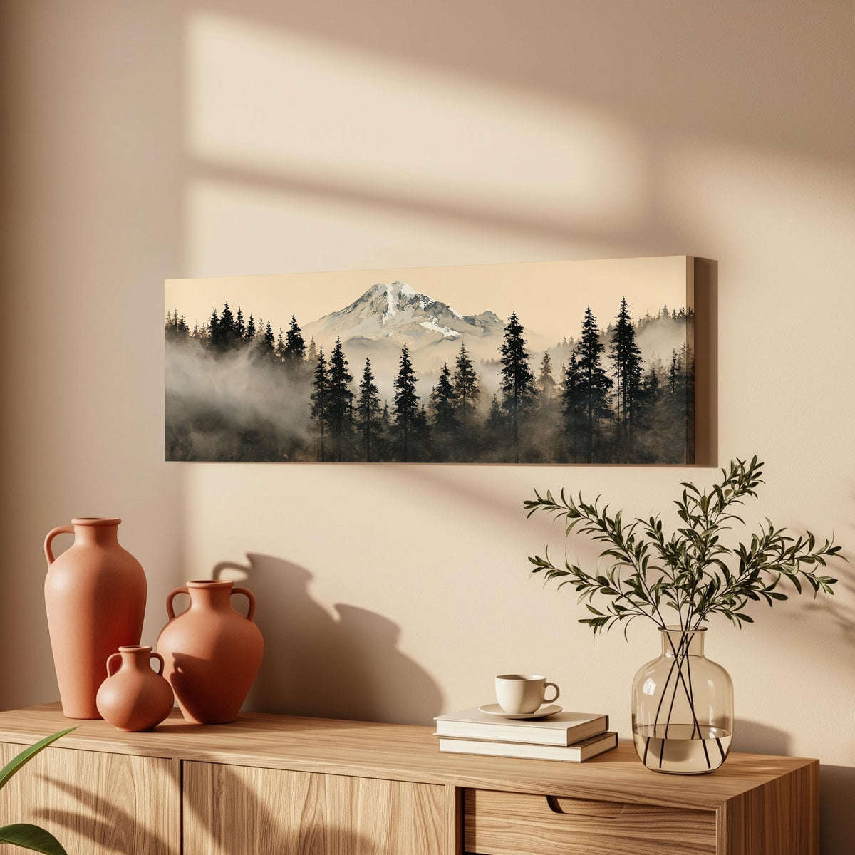 Foggy pine forest below a snowy mountain long horizontal canvas print above a wooden sideboard