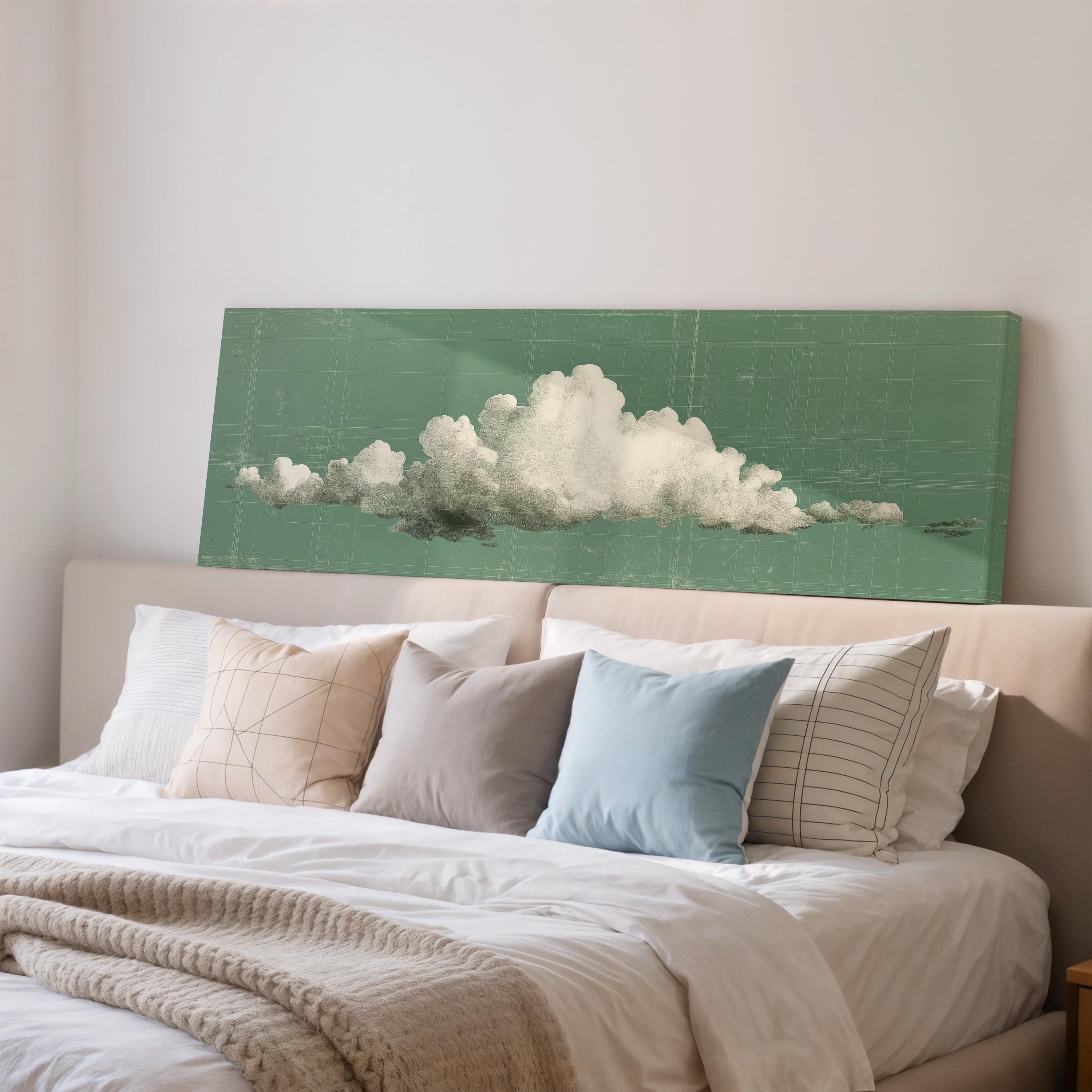 a large green canvas with a white cloud design on it, which is mounted on a wall above a bed with white pillows and a gray blanket.