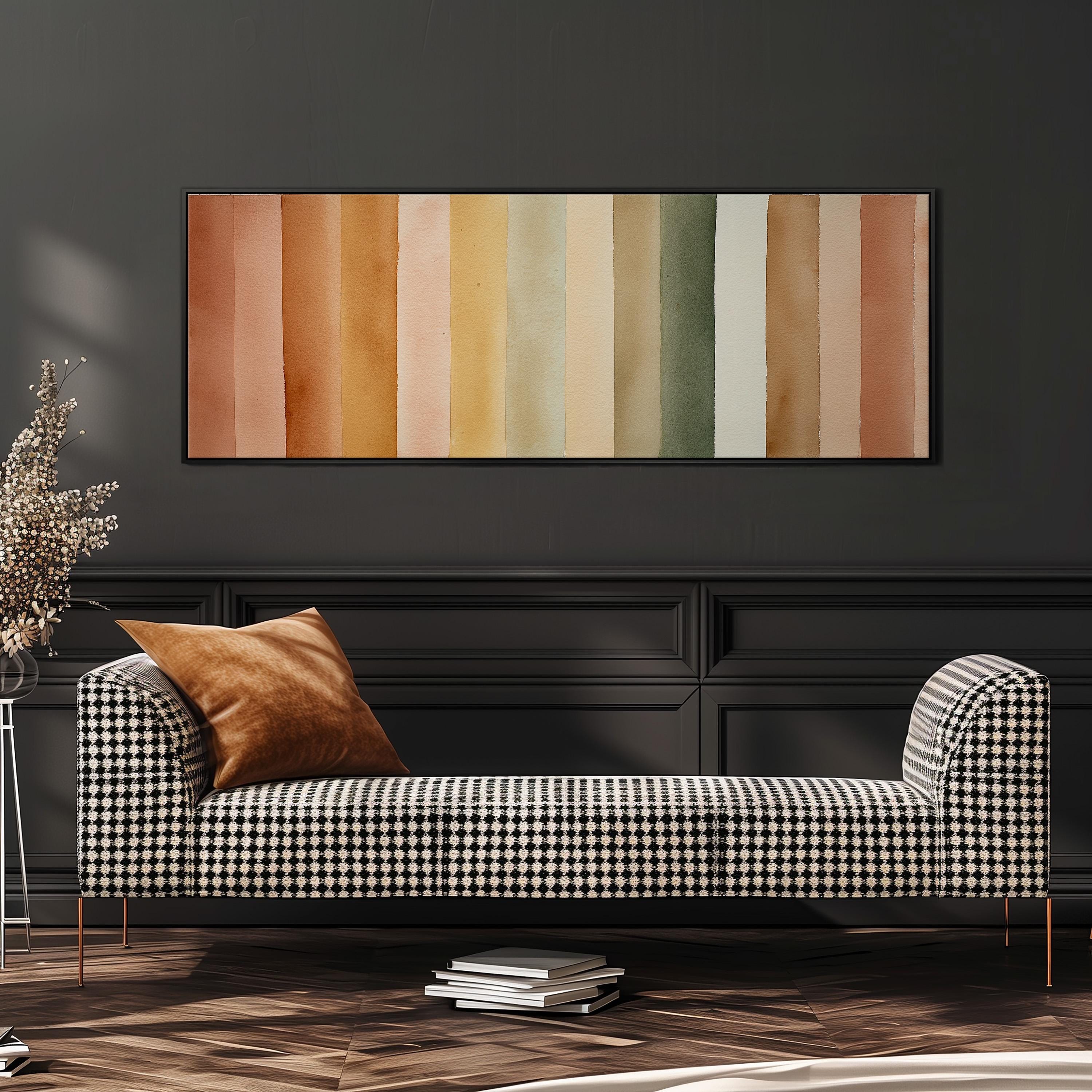 a modern living room with a black and white checkered sofa, a stack of books, and a large abstract painting on the wall.