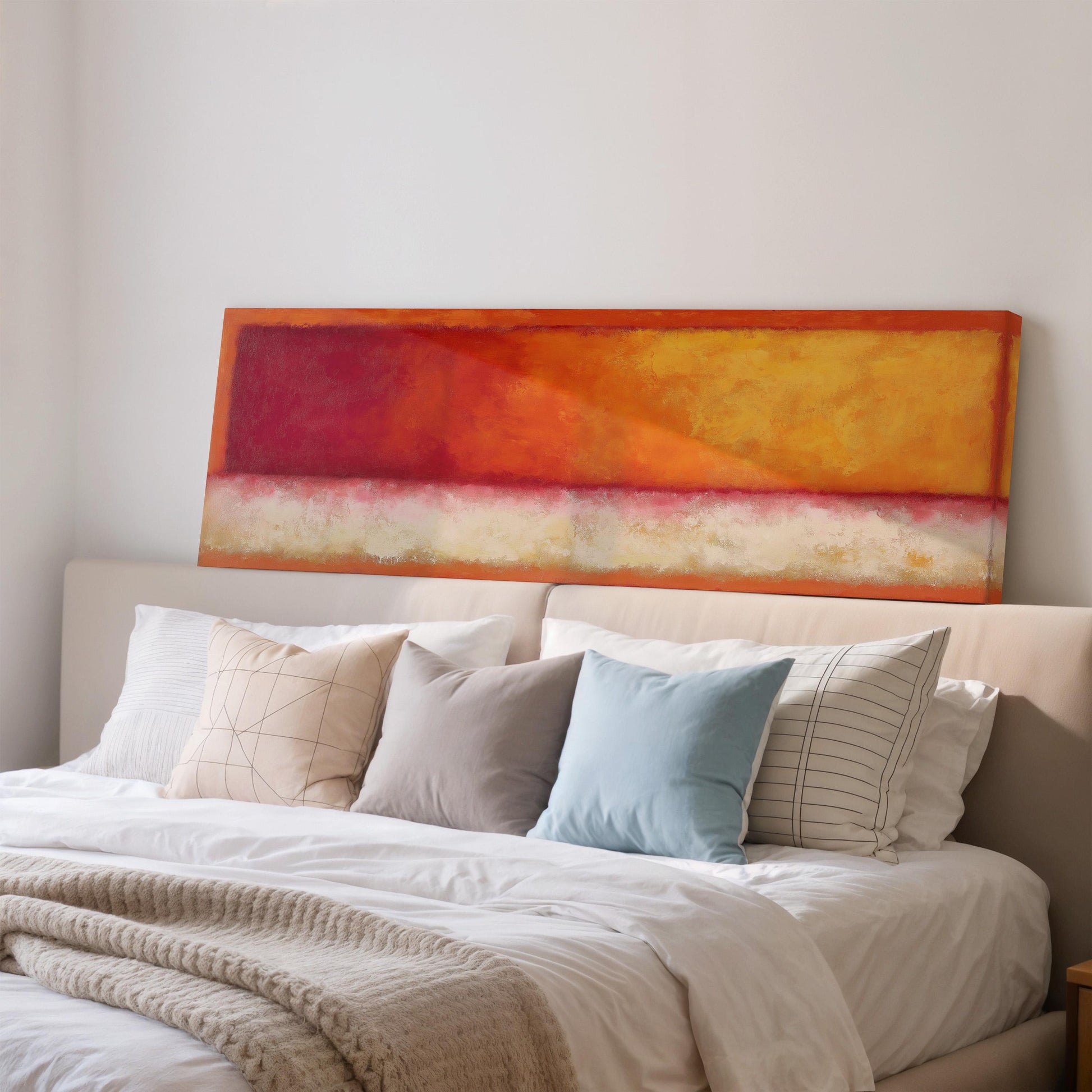 a cozy bedroom with a large bed adorned with white linens and a vibrant orange and red abstract painting hanging above it.