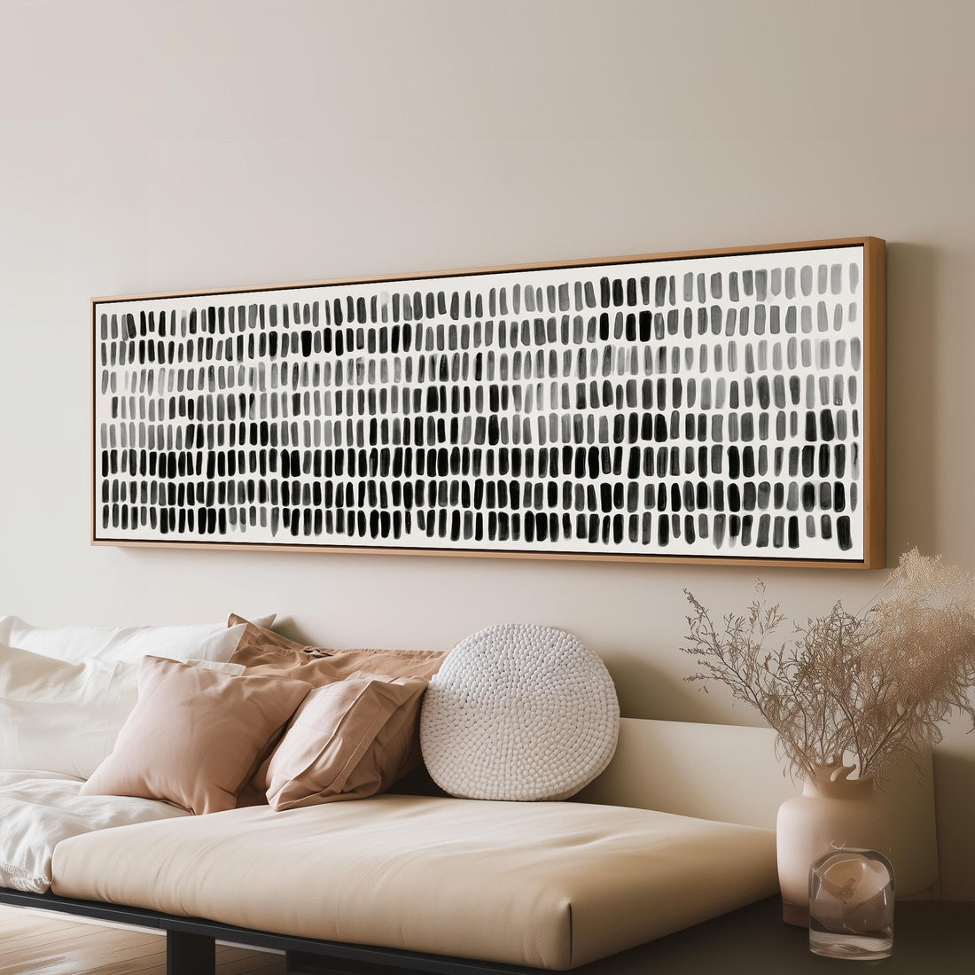 Grid of black and grey brushmarks long horizontal canvas print above a sofa in a living room