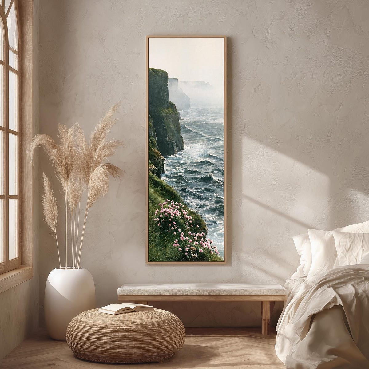 Misty sea cliffs with pink wildflowers long vertical canvas print in a bright reading corner