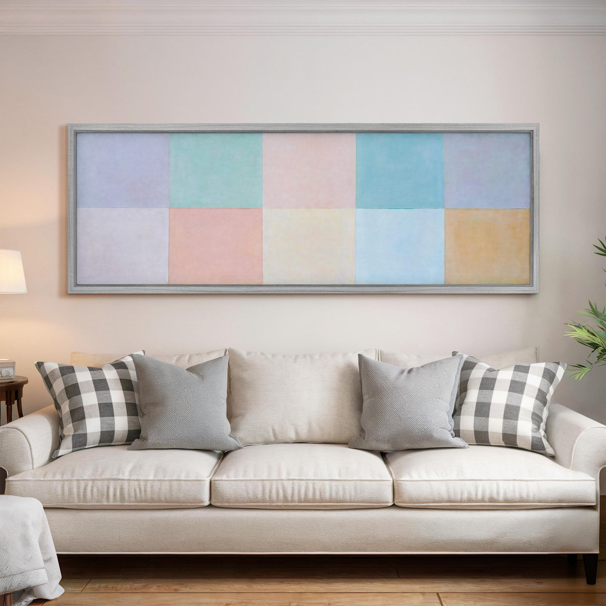 Pastel checkerboard grid panoramic canvas print above a white sofa in a bright living room