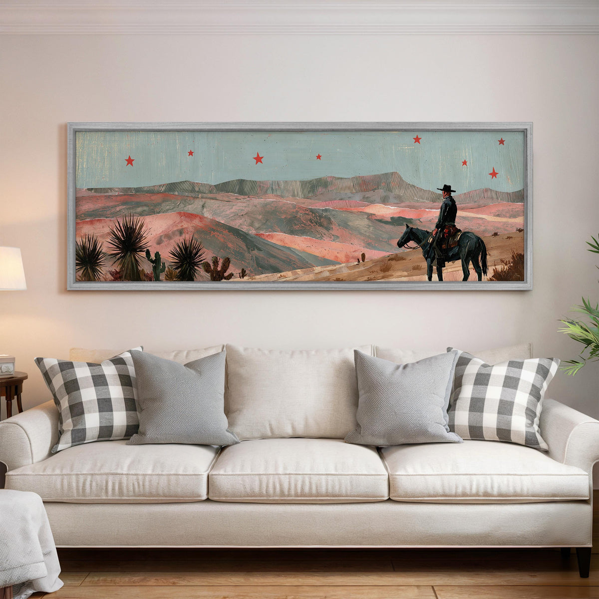 Desert cowboy under red stars panoramic canvas print above a white sofa in a bright living room