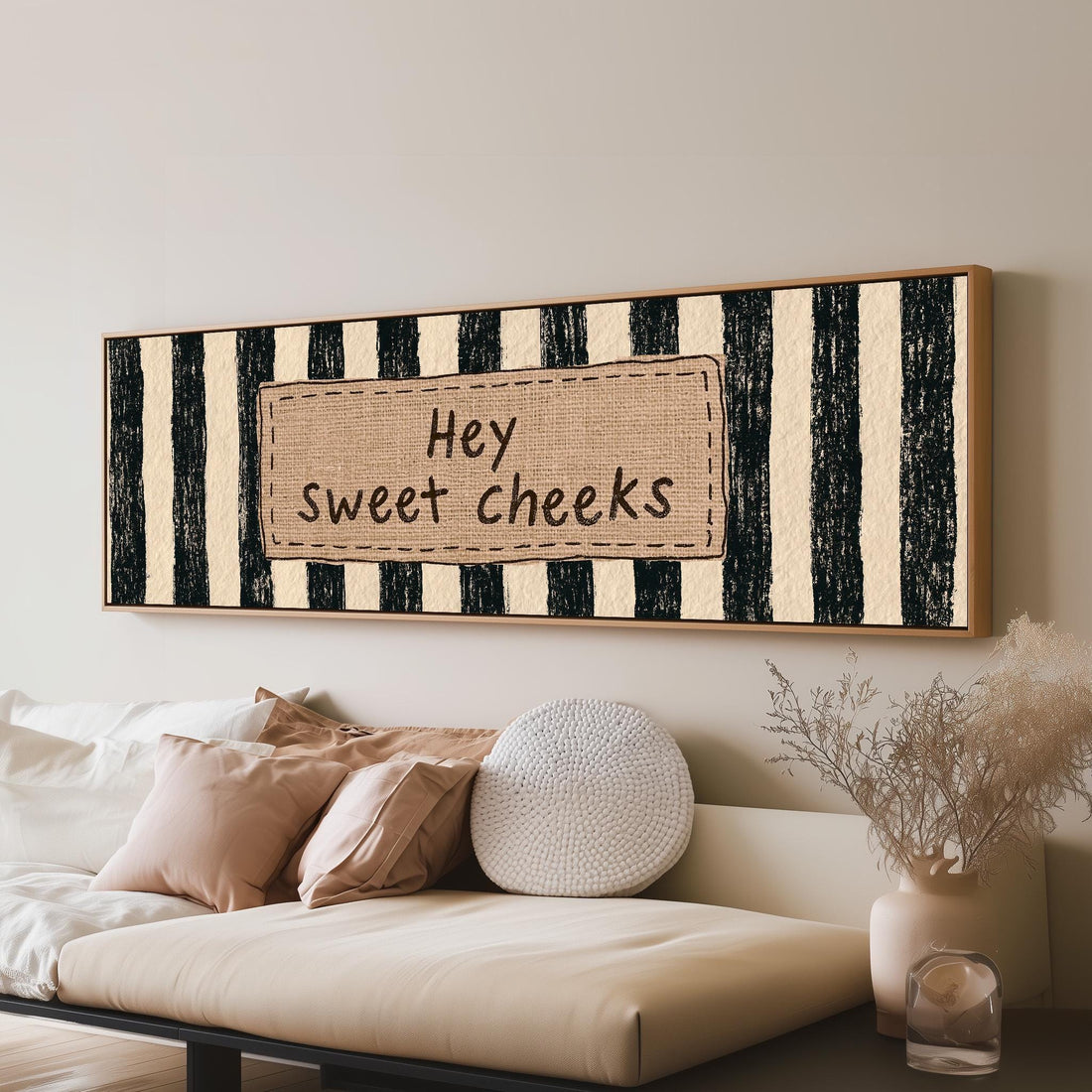 Hey sweet cheeks sign on black stripes long horizontal canvas print above a sofa in a living room